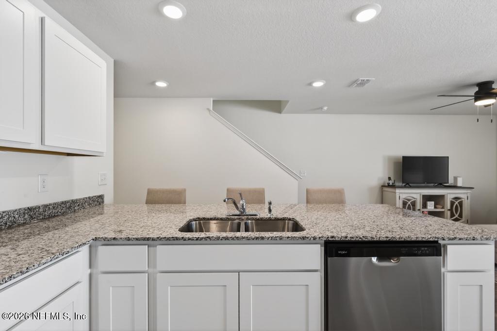45124 Red Brick Drive Callahan, FL 32011 - Photo 14 of 54 a kitchen with granite countertop a sink and a stove top oven with granite countertops