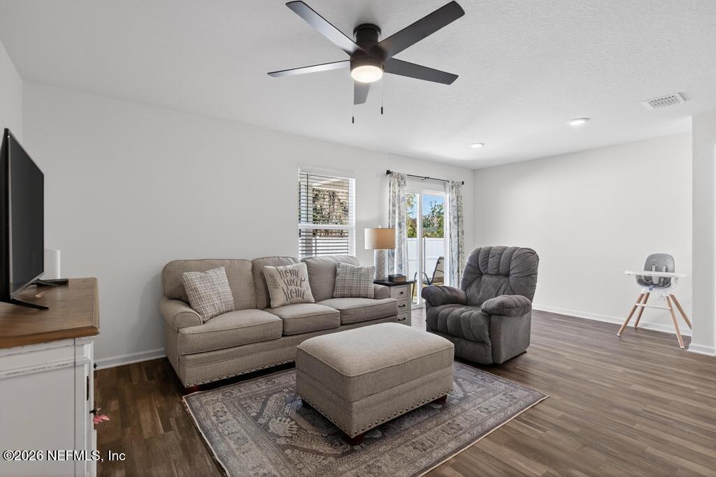 45124 Red Brick Drive Callahan, FL 32011 - Photo 18 of 54 a living room with furniture and a flat screen tv