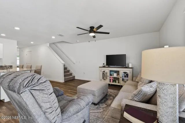a living room with furniture and a flat screen tv