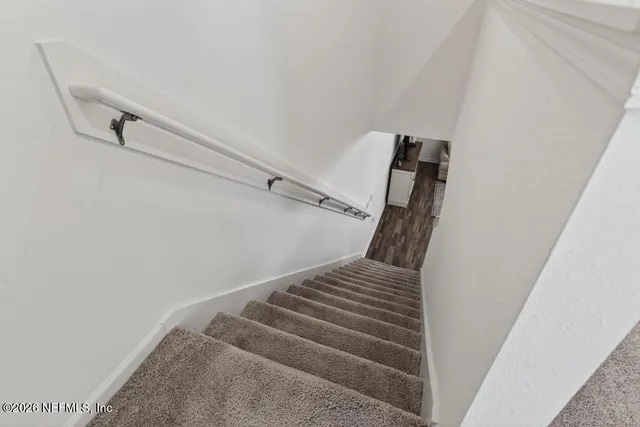 a view of staircase with white walls