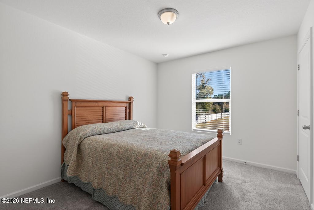 45124 Red Brick Drive Callahan, FL 32011 - Photo 30 of 54 a bedroom with a bed and a window