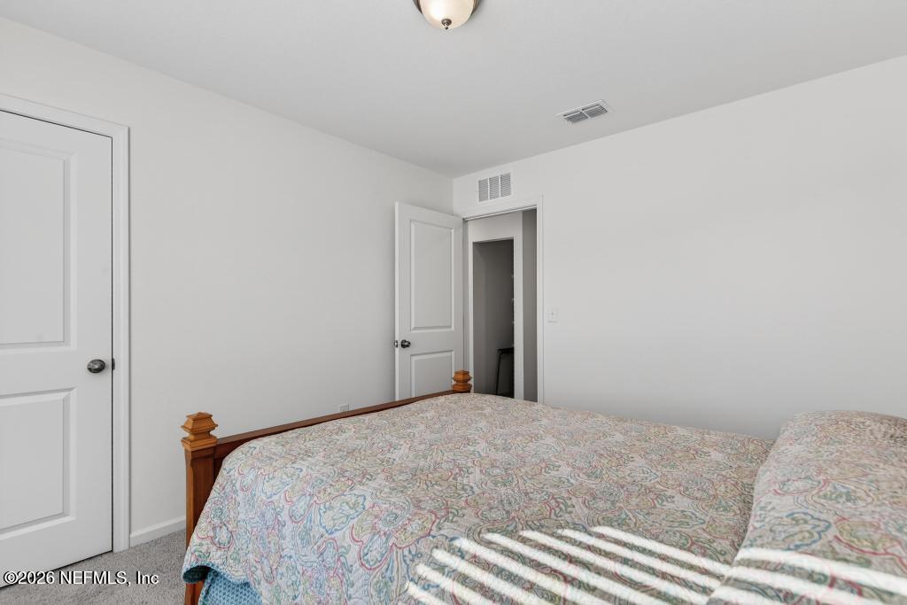 45124 Red Brick Drive Callahan, FL 32011 - Photo 32 of 54 a bedroom with a bed and a window