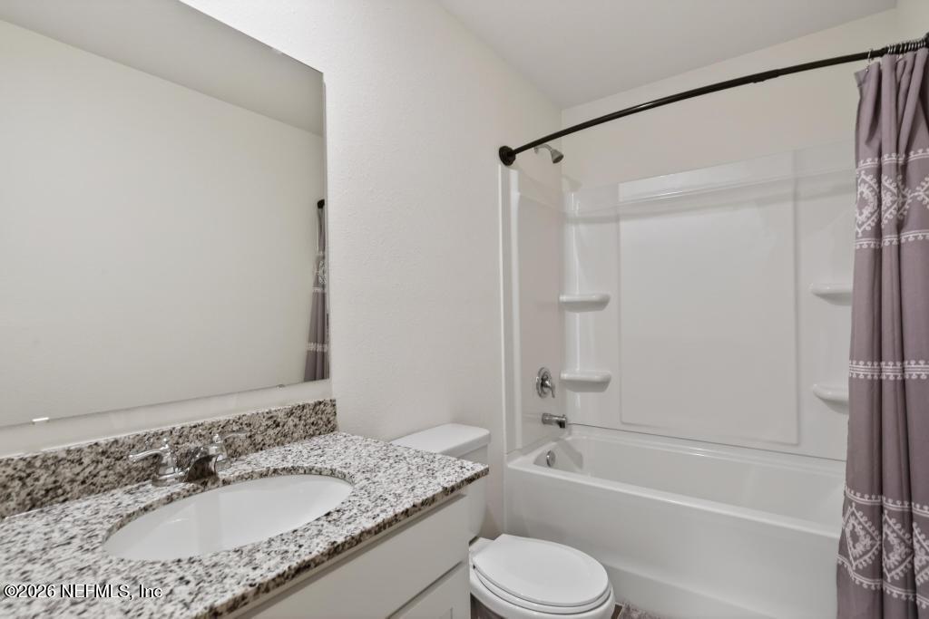 45124 Red Brick Drive Callahan, FL 32011 - Photo 34 of 54 a bathroom with a granite countertop sink toilet and shower
