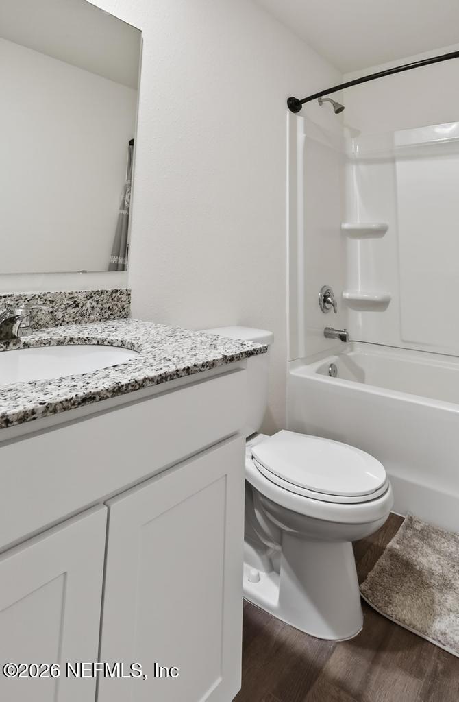 45124 Red Brick Drive Callahan, FL 32011 - Photo 35 of 54 a bathroom with a granite countertop toilet sink and shower