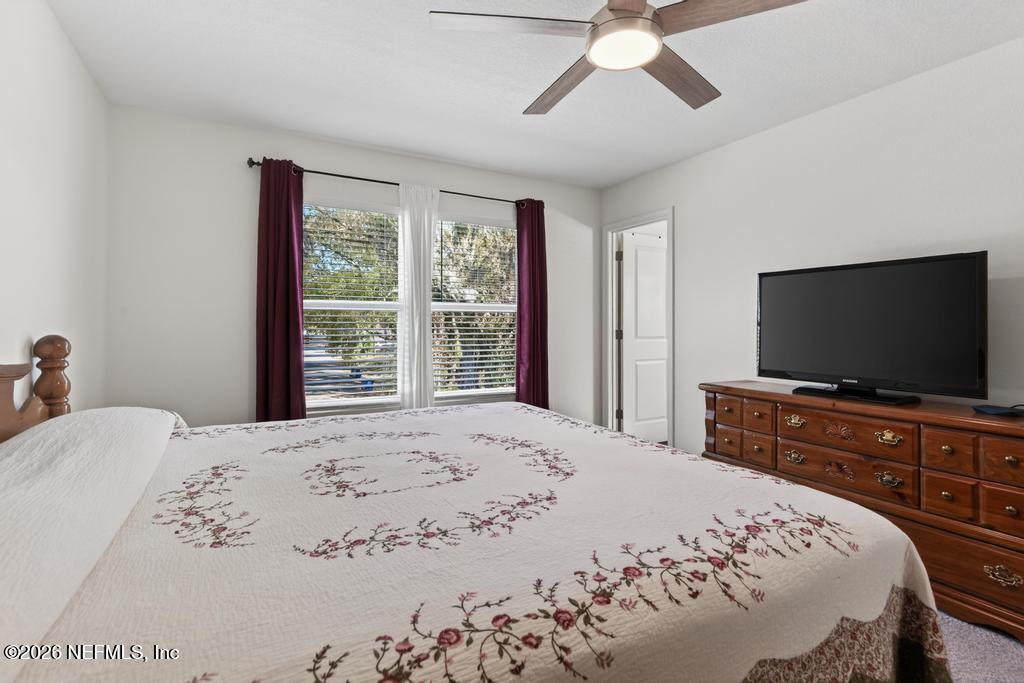 45124 Red Brick Drive Callahan, FL 32011 - Photo 37 of 54 a bedroom with a bed and a flat screen tv on dresser