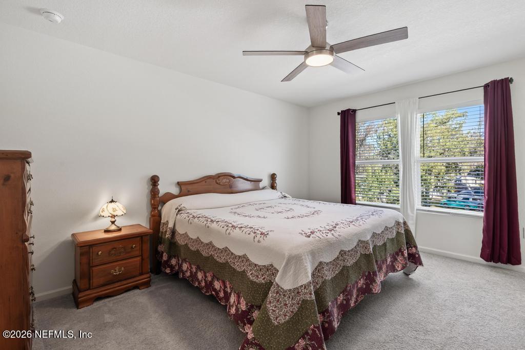 45124 Red Brick Drive Callahan, FL 32011 - Photo 38 of 54 a bedroom with a bed and a chandelier