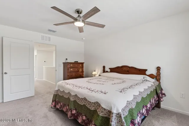 a bedroom with a bed and a television