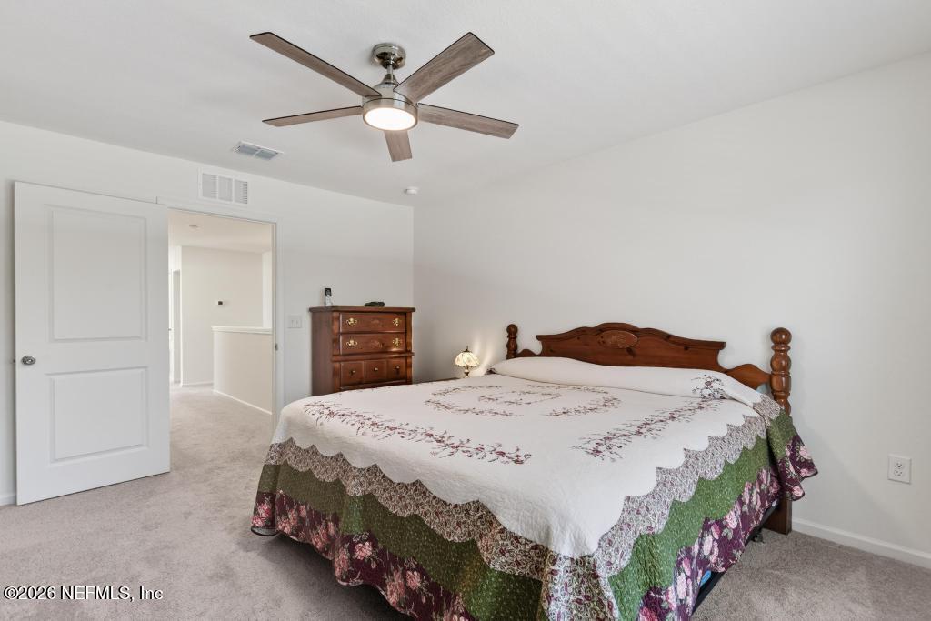 45124 Red Brick Drive Callahan, FL 32011 - Photo 39 of 54 a bedroom with a bed and a chandelier