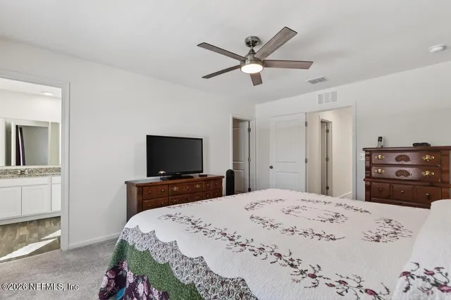 a bathroom with a granite countertop sink a mirror and a vanity