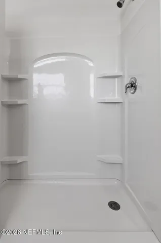 a view of walk in closet with clothes