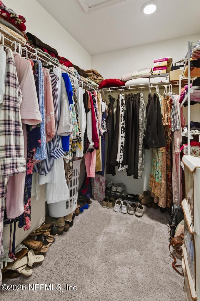45124 Red Brick Drive Callahan, FL 32011 - Photo 45 of 54 a view of walk in closet with clothes