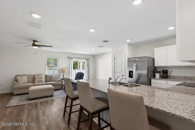 a living room with kitchen island furniture and a kitchen view