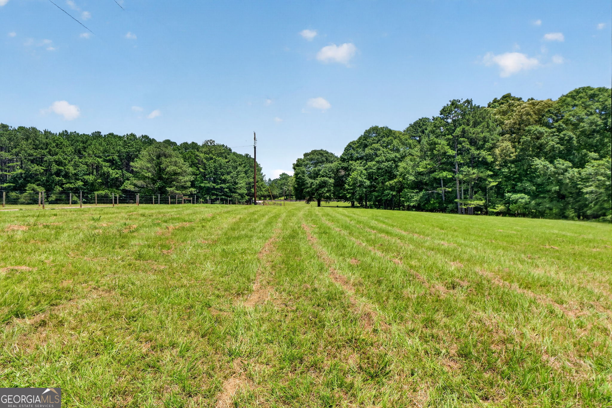 242 Harris Road Concord, GA 30206 - Photo 54 of 55 a view of a green field with trees in the background