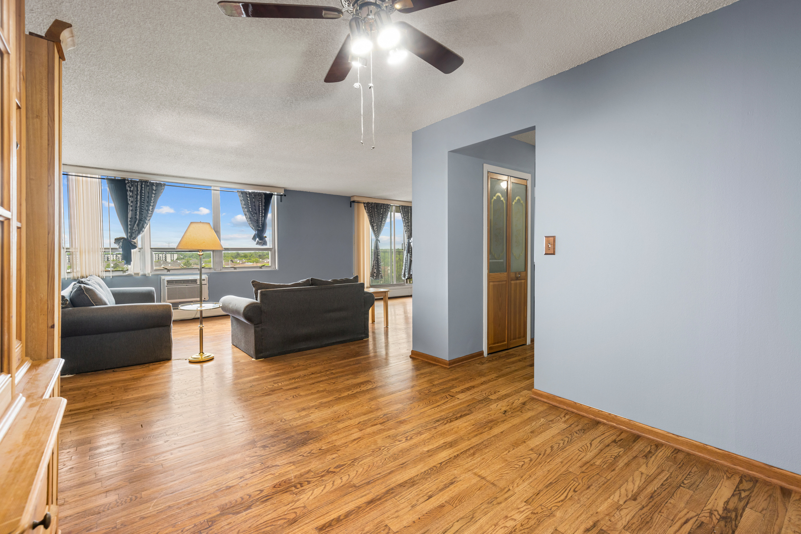 8815 West Golf Road, Unit 7A Niles, IL 60714 - Photo 11 of 26 a living room with furniture and a chandelier