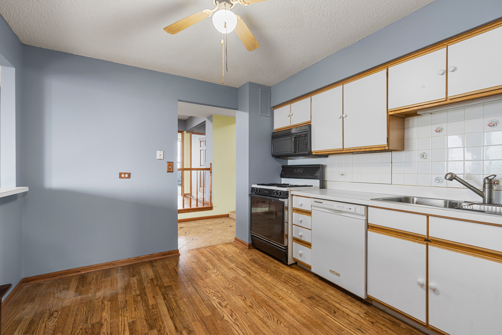 8815 West Golf Road, Unit 7A Niles, IL 60714 - Photo 14 of 26 a kitchen with stainless steel appliances granite countertop a stove cabinets and wooden floor