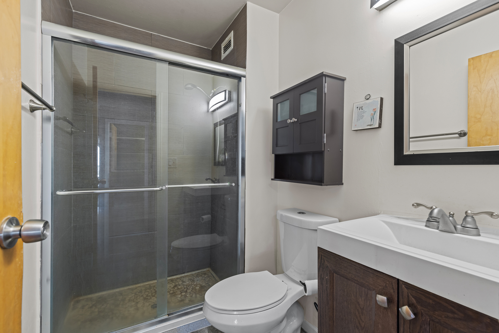 8815 West Golf Road, Unit 7A Niles, IL 60714 - Photo 17 of 26 a bathroom with a sink a toilet a mirror and shower