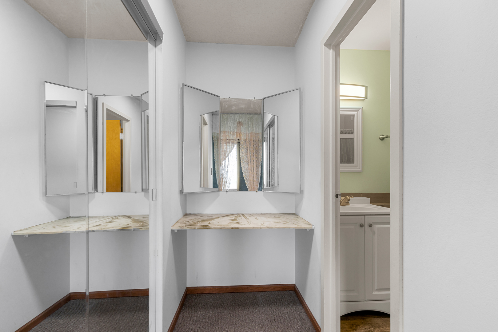 8815 West Golf Road, Unit 7A Niles, IL 60714 - Photo 20 of 26 a en suite bathroom with a granite countertop sink and a mirror