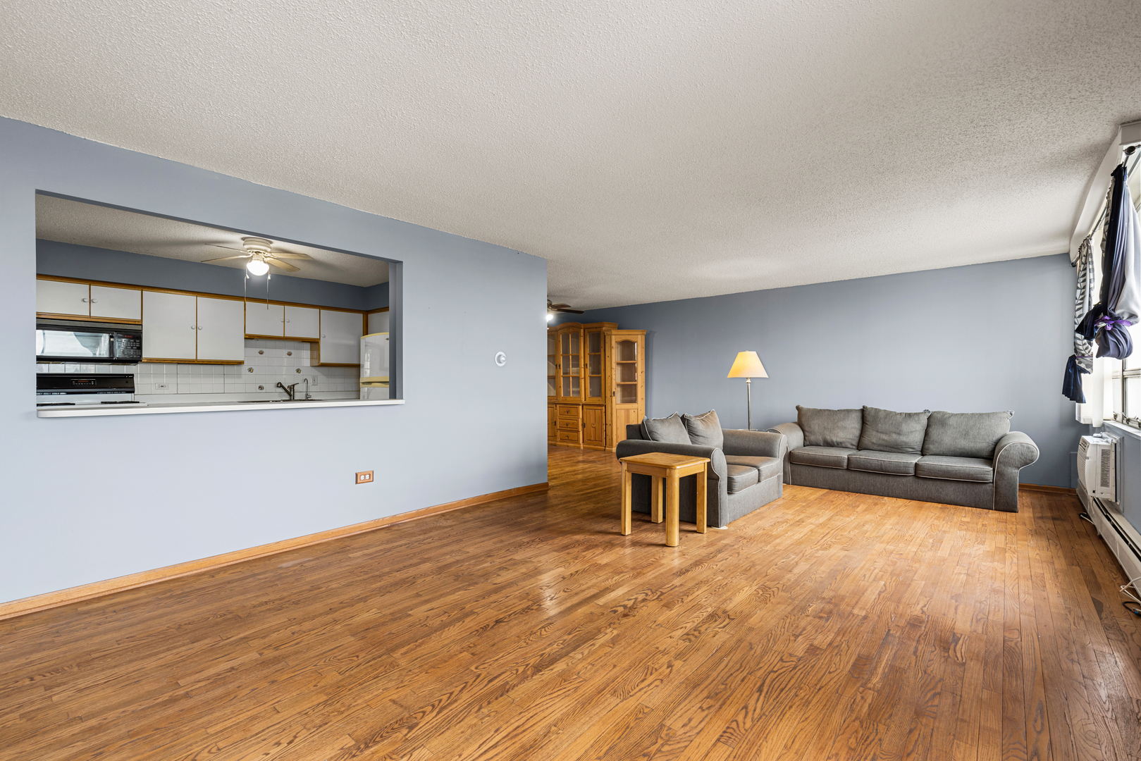 8815 West Golf Road, Unit 7A Niles, IL 60714 - Photo 7 of 26 a living room with furniture and a wooden floor