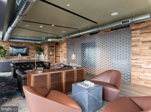 a dining room with furniture and a floor to ceiling window