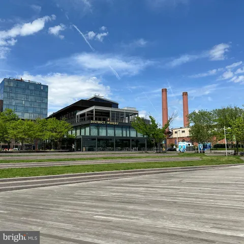 a view of a big building in a big yard with large trees