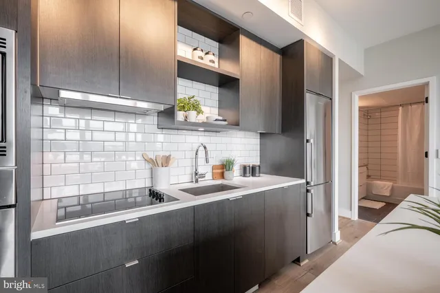 a kitchen with a sink a counter top space and cabinets