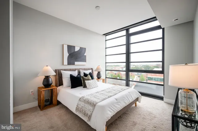 a bedroom with a large bed and a window