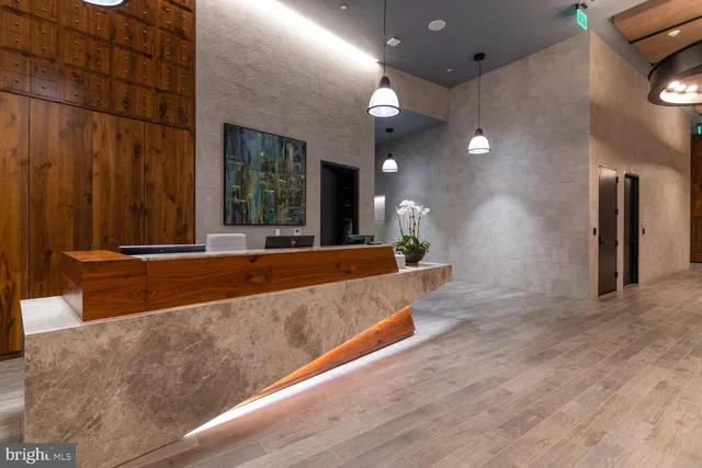 a large living room with stainless steel appliances kitchen island granite countertop furniture and a large window