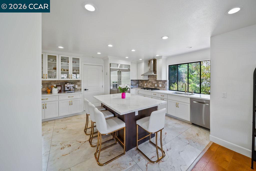 172 Rudgear Drive Walnut Creek, CA 94596 - Photo 22 of 51 a kitchen with a table chairs refrigerator and cabinets
