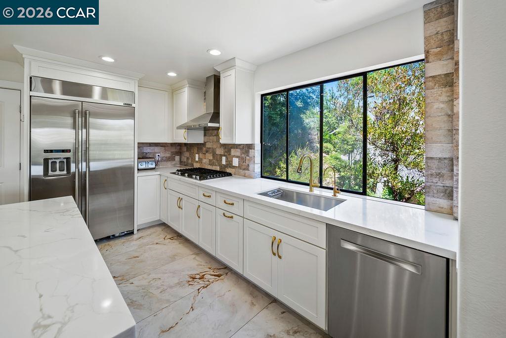 172 Rudgear Drive Walnut Creek, CA 94596 - Photo 9 of 51 a large kitchen with kitchen island granite countertop a large window and stainless steel appliances