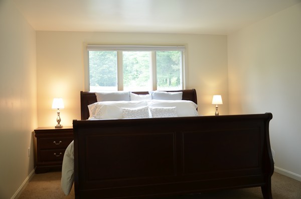 3 West Whitehall Road Amesbury, MA 01913 - Photo 13 of 18 a living room with a large window and wooden floor