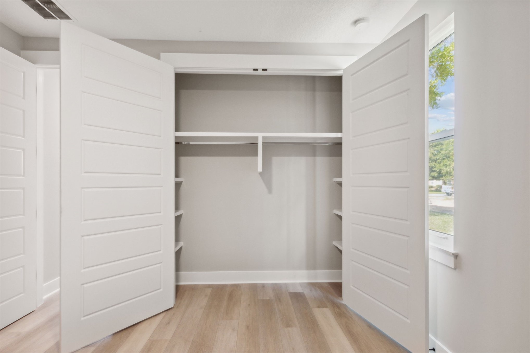 96050 Captains Pointe Road Yulee, FL 32097 - Photo 30 of 36 a view of walk in closet with empty racks