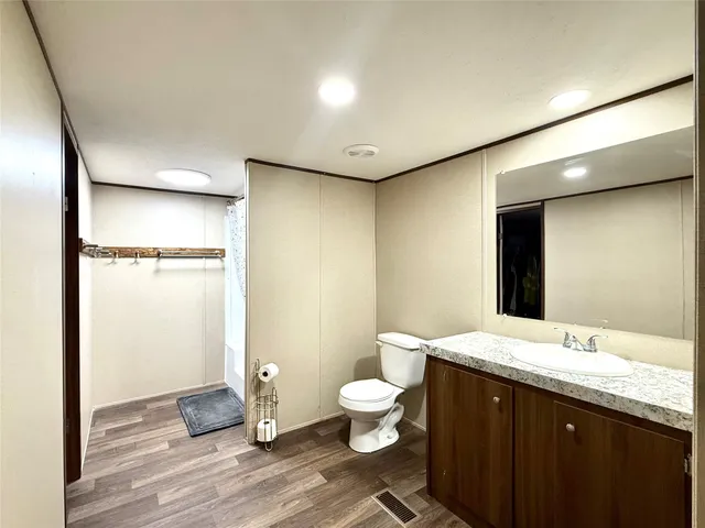 a bathroom with a double vanity sink toilet and a mirror