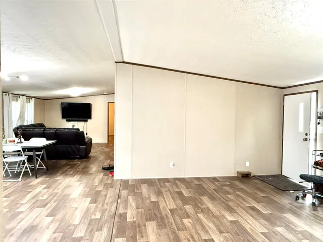 a view of a livingroom with furniture and a flat screen tv