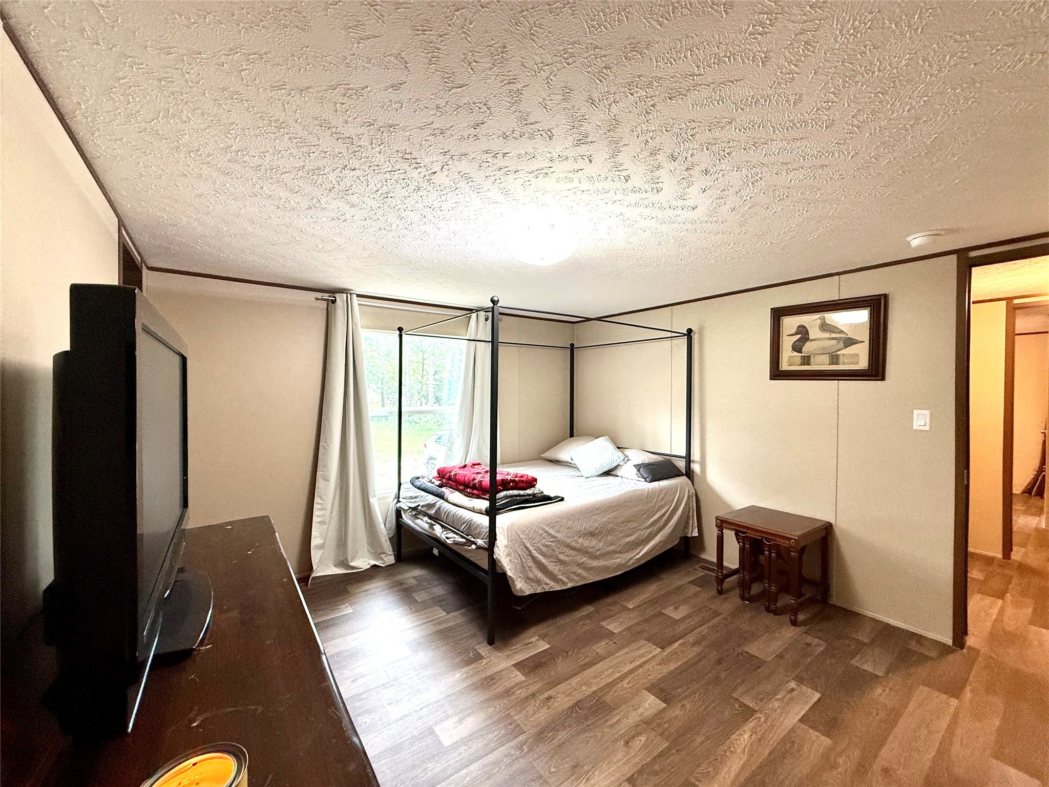 17008 FM 1484 Road Conroe, TX 77303 - Photo 29 of 36 a spacious bedroom with a bed and a window