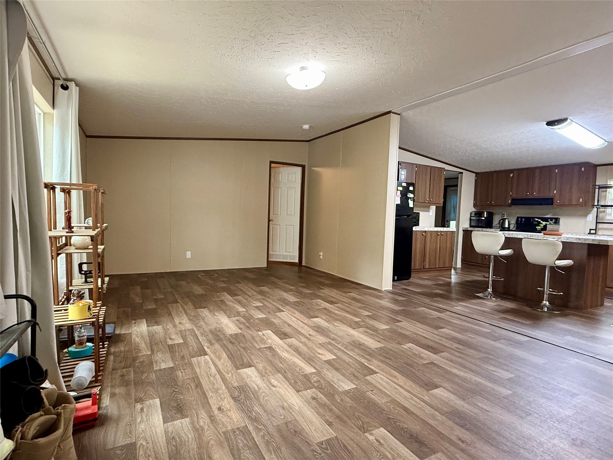 17008 FM 1484 Road Conroe, TX 77303 - Photo 3 of 36 a view of kitchen and living room with wooden floor