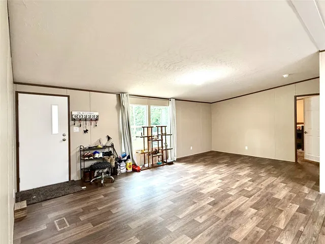 a view of a livingroom with furniture and a window