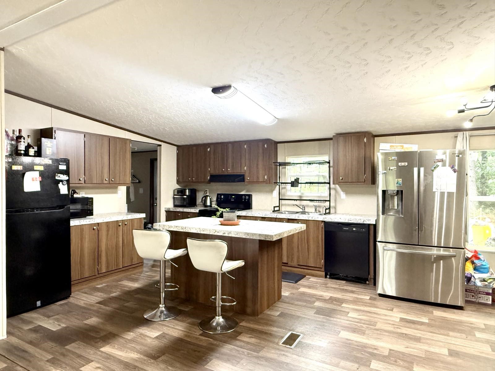 17008 FM 1484 Road Conroe, TX 77303 - Photo 6 of 36 a kitchen with a sink a kitchen island and stainless steel appliances