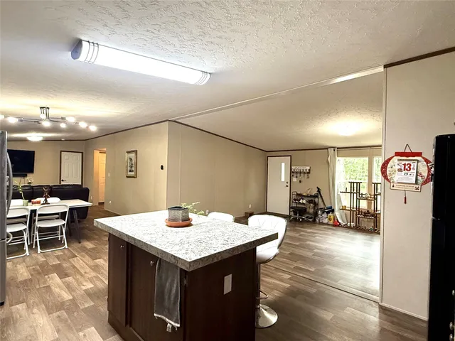 a large kitchen with a table and chairs
