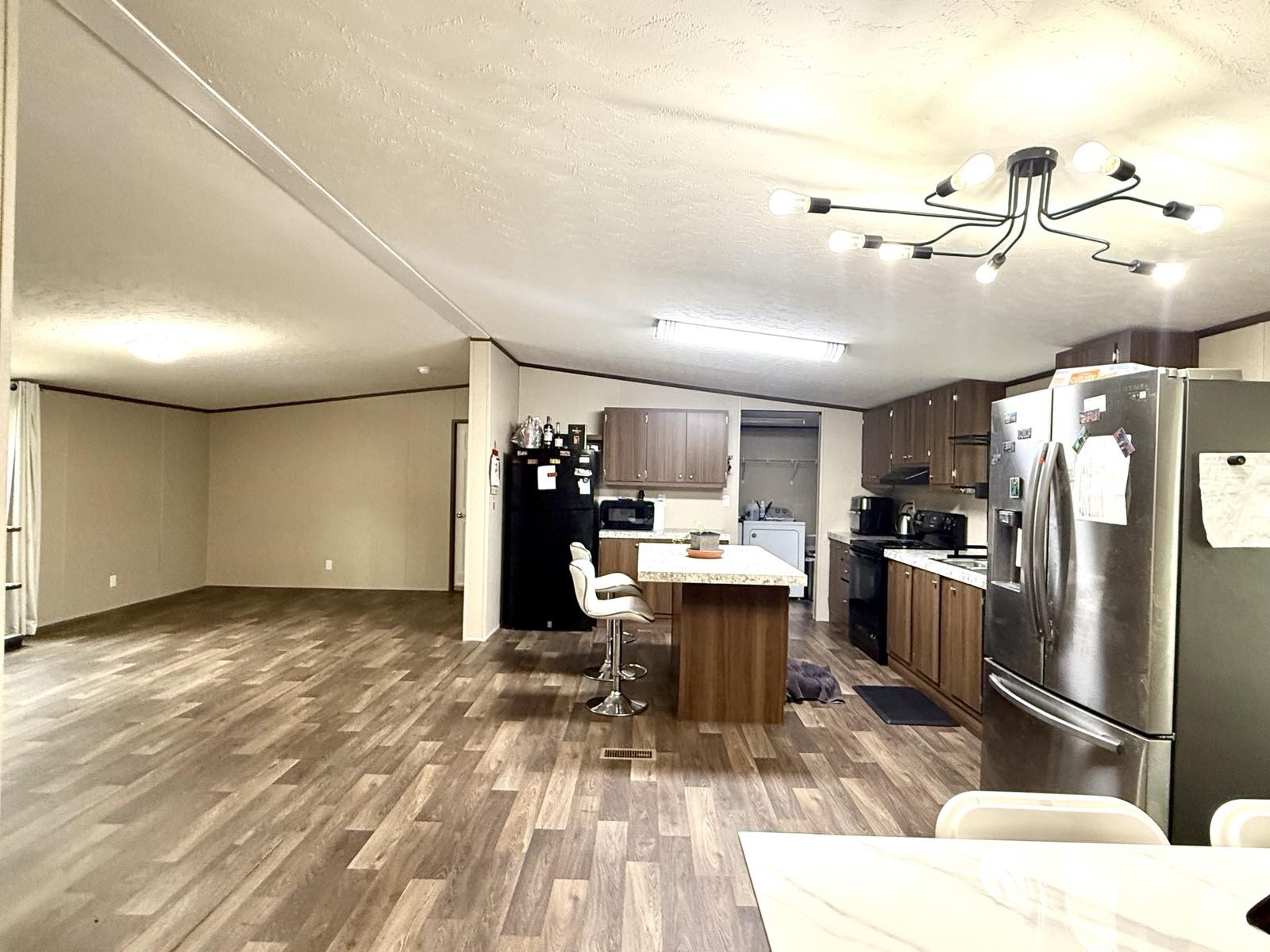 17008 FM 1484 Road Conroe, TX 77303 - Photo 10 of 36 a living room with stainless steel appliances kitchen island granite countertop a table chairs in it and a window