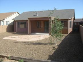 4785 Edgemont Road Prescott Valley, AZ 86314 - Photo 8 of 9 a front view of a house with a yard and garage