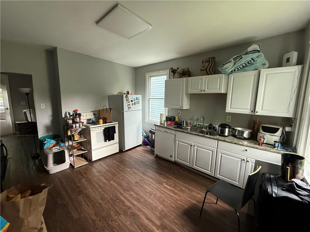 1336 Complete Street Pittsburgh, PA 15212 - Photo 4 of 14 a kitchen with stainless steel appliances a stove a sink dishwasher and cabinets with wooden floor
