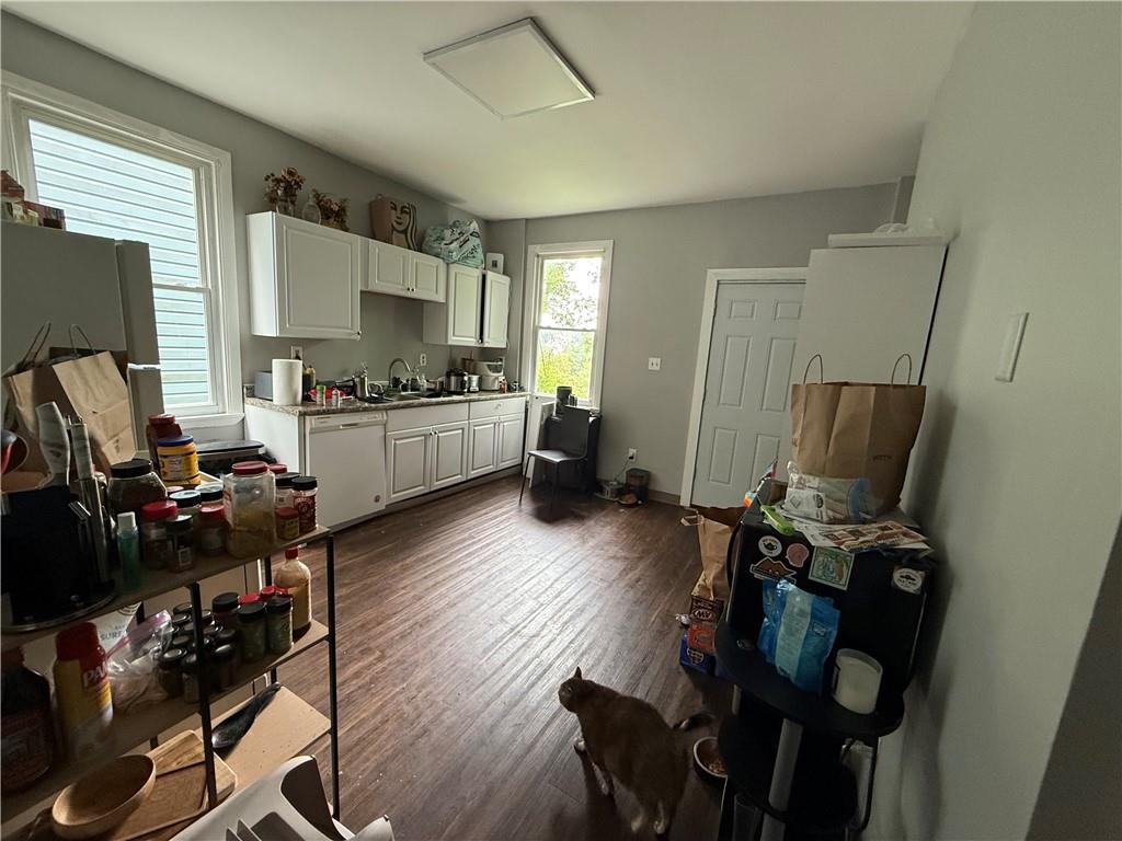 1336 Complete Street Pittsburgh, PA 15212 - Photo 5 of 14 a kitchen with a sink stove and wooden floor