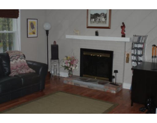 122 Sarah Sherman Road Rochester, MA 02770 - Photo 3 of 4 a living room with furniture and a fireplace