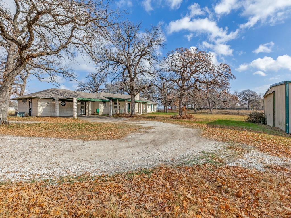 7335 Reed Road Azle, TX 76020 - Photo 2 of 36 a front view of a house with a yard