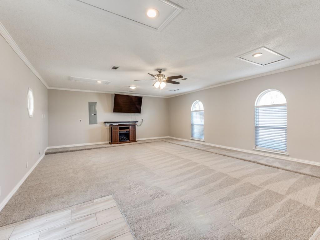 7335 Reed Road Azle, TX 76020 - Photo 23 of 36 an empty room with windows and fireplace