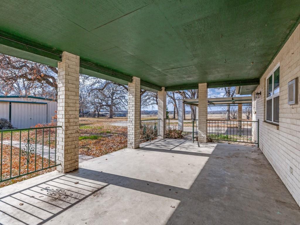 7335 Reed Road Azle, TX 76020 - Photo 4 of 36 a view of a balcony with floor to ceiling windows with wooden floor