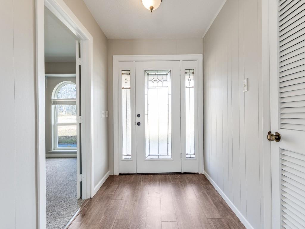 7335 Reed Road Azle, TX 76020 - Photo 8 of 36 an empty room with wooden floor closet and windows