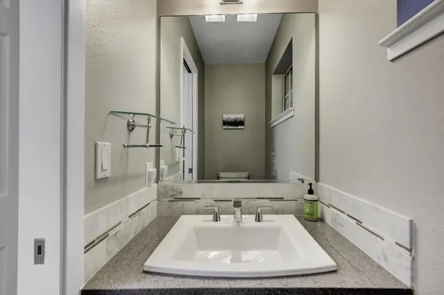 a bedroom with a bed and a painting on the wall