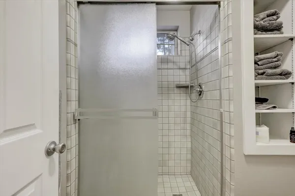 a view of a big house with large trees and a small yard