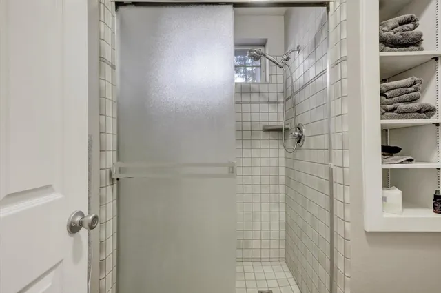 a view of a big house with large trees and a small yard